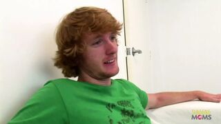 At work, a slender individual engages in sexual intercourse with a coworker who has a striking red hair